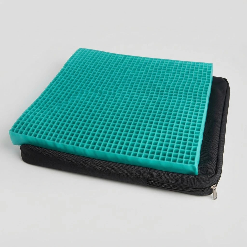 Teal honeycomb gel seat cushion insert resting on top of an unzipped black fabric cover.
