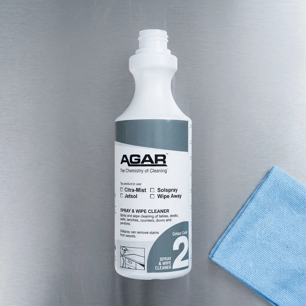 Antibacterial spray and wipe cleaner being applied to a commercial kitchen benchtop for a streak free finish.