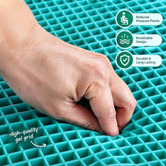Close-up of a hand pressing into a high-quality teal gel grid cushion demonstrating flexibility and pressure relief.