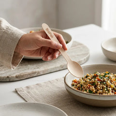 Close up of a smooth wax free wooden ice cream spoon showing a splinter free surface and food grade finish.