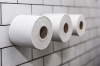 buy-three-rolls-of-toilet-paper-on-white-tile-wall